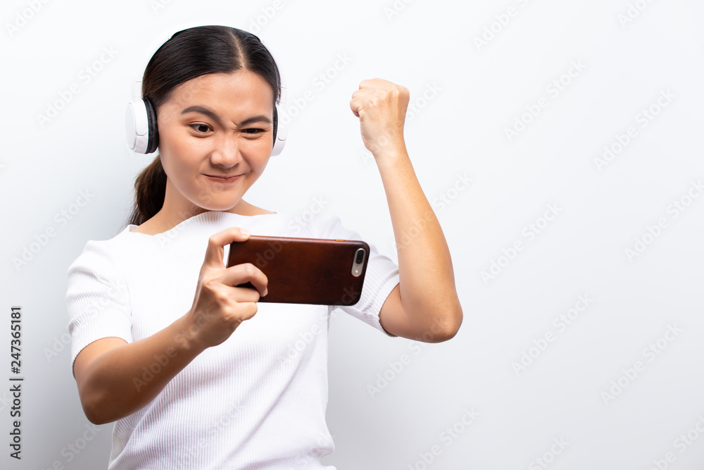 Happy woman playing to the game from smartphone Happy woman playing to the game from smartphone