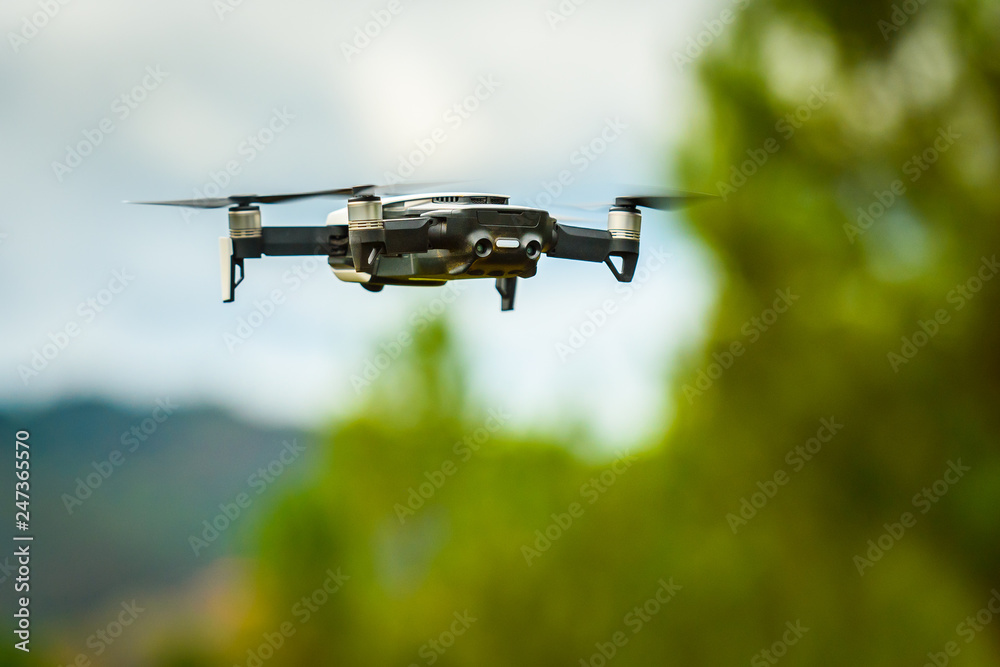 Drone quadcopter UAV with digital camera flying in the sky. Drone quadcopter UAV with digital camera flying in the sky.