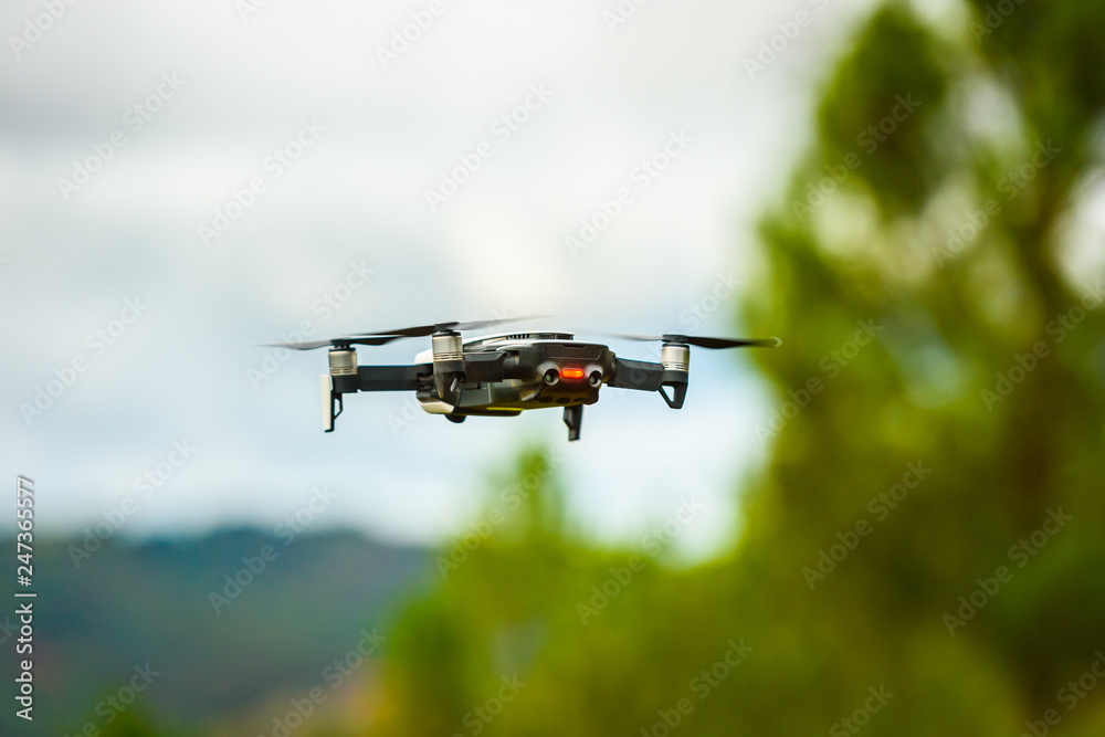 Drone quadcopter UAV with digital camera flying in the sky. Drone quadcopter UAV with digital camera flying in the sky.