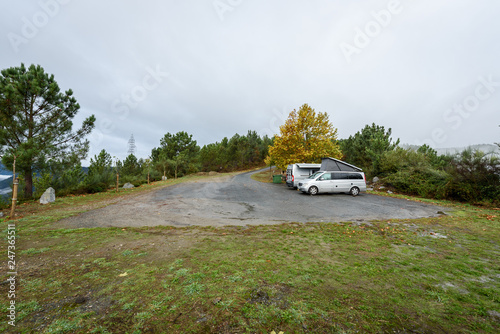 Campervan and motorhome camping on rainy day in nature parking. © _jure