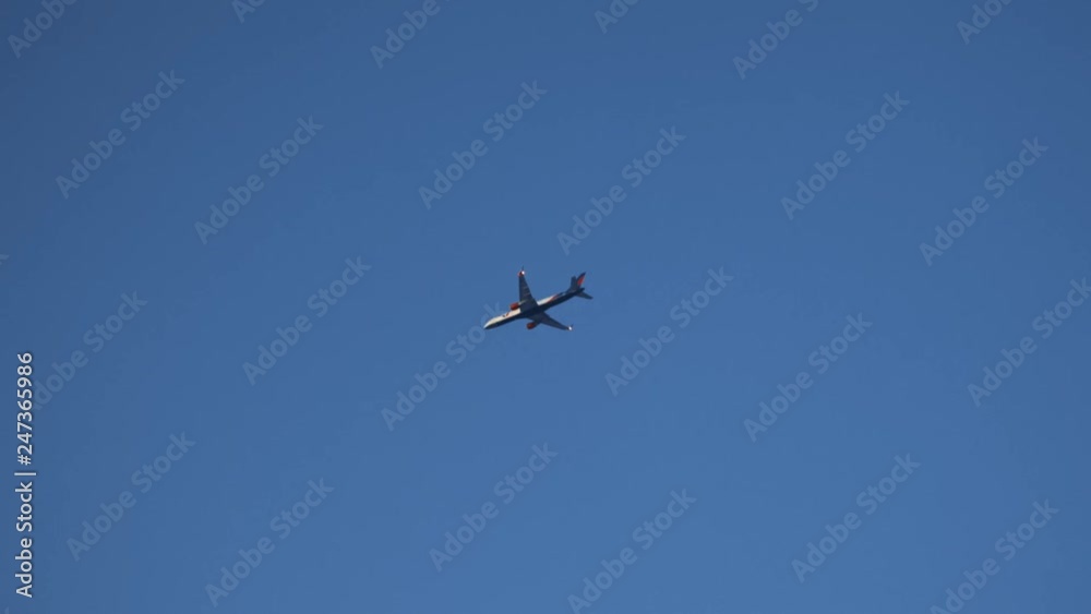 Passenger airplane flying in clear blue sky. Bottom View. Freedom concept. Safety People Transportation, fast moving on high altitude. Travel concept Passenger airplane flying in clear blue sky. Bottom View. Freedom concept. Safety People Transportation, fast moving on high altitude. Travel concept