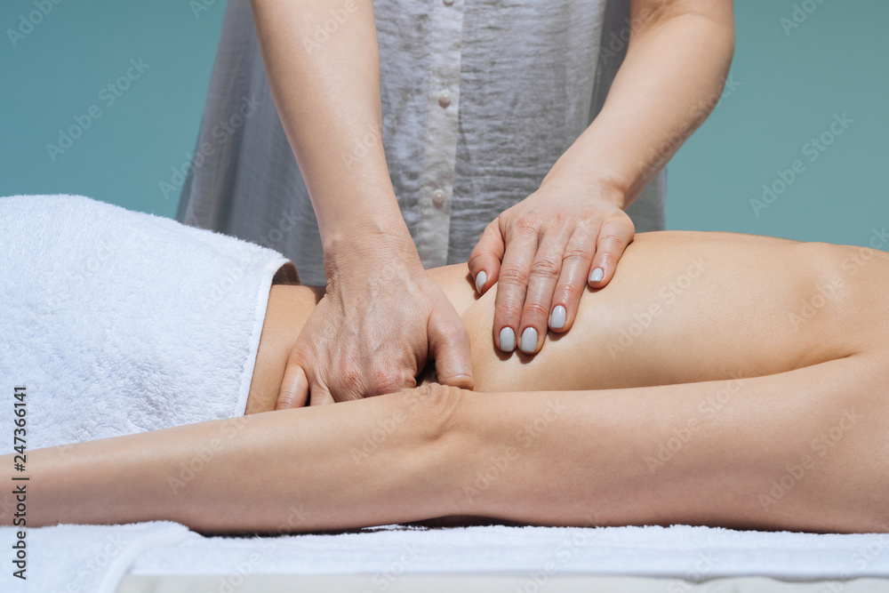 Hands of unrecognisable woman masseur doing back massage at salon. Hands of unrecognisable woman masseur doing back massage at salon.