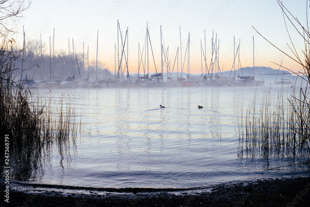 harbor with sailboats at dawn on Lake Maggiore in winter