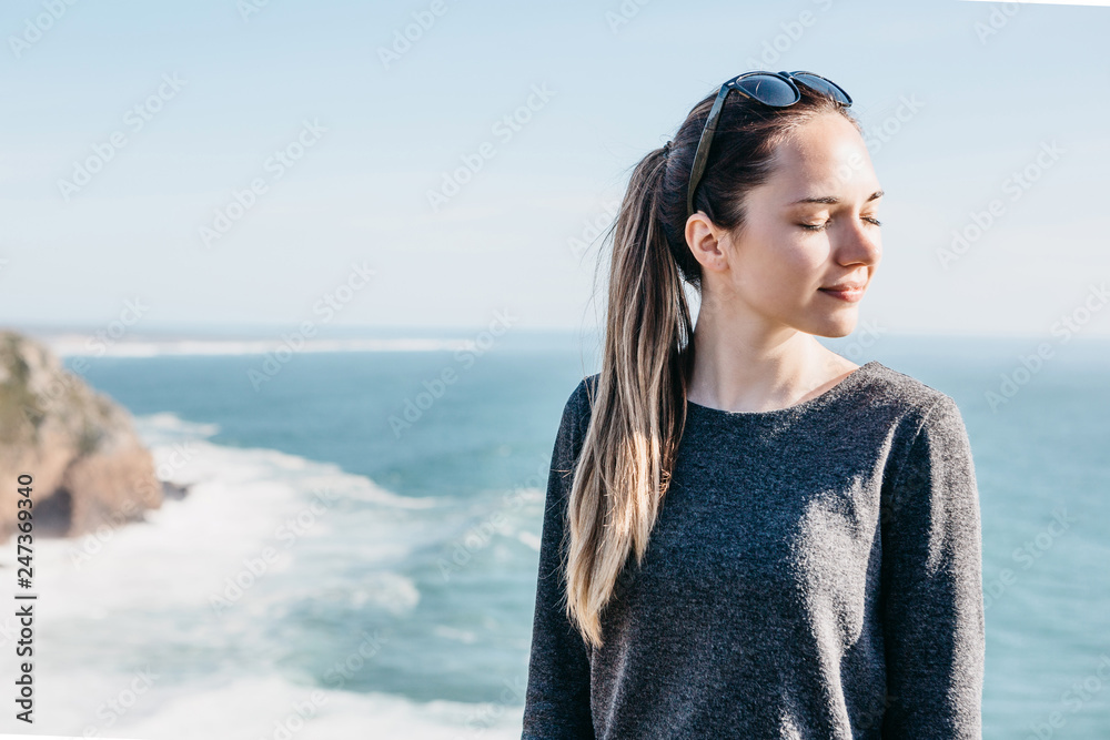 Beautiful young girl in sunglasses closed her eyes and enjoys the sun and sunbathes. Beautiful young girl in sunglasses closed her eyes and enjoys the sun and sunbathes.