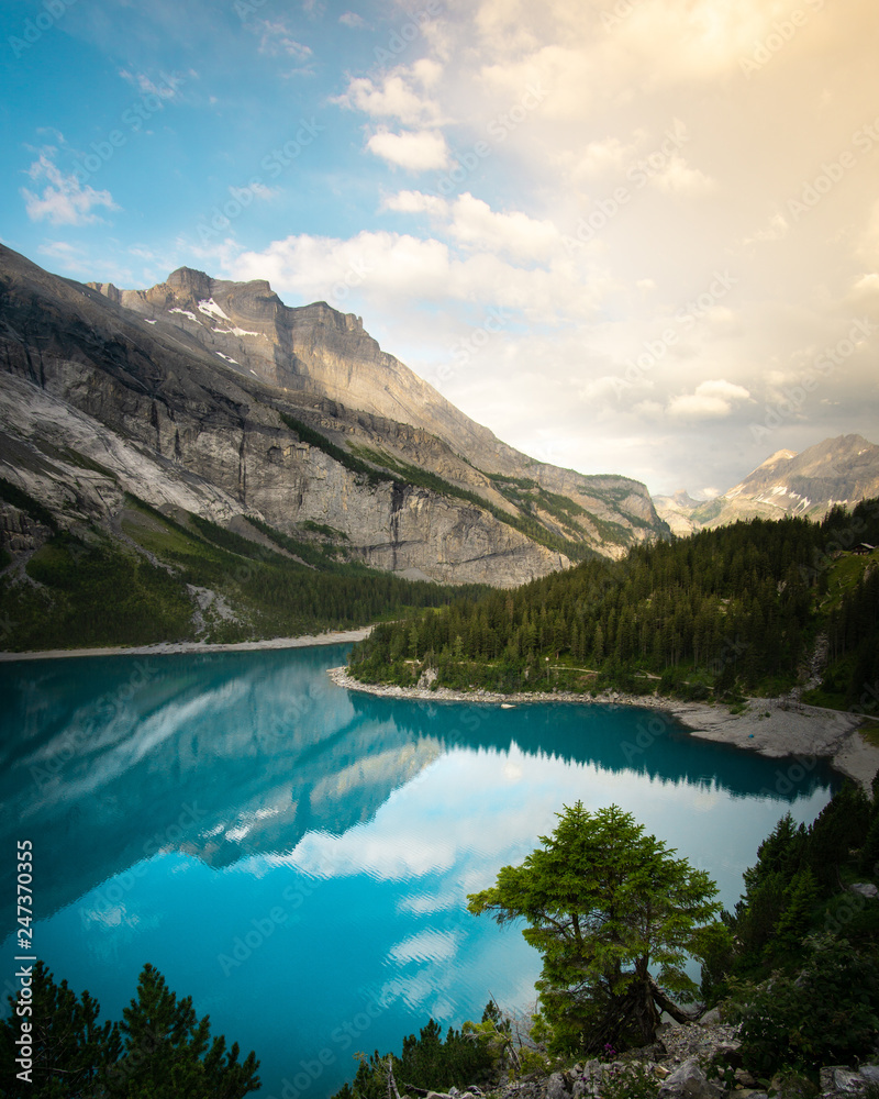 Blue turquoise waters of lake Oeschinensee in Swiss Alps