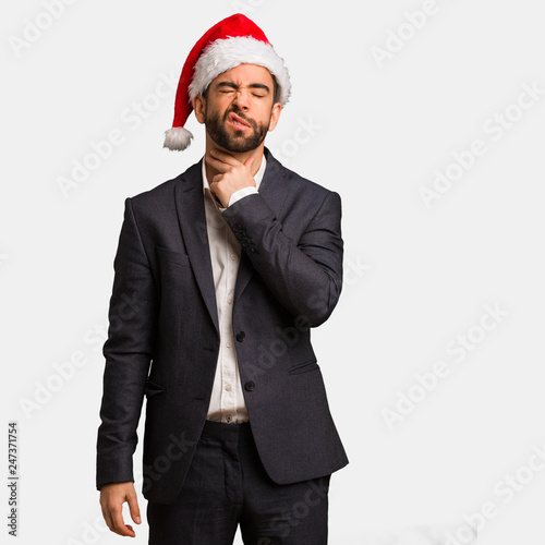 Young business man wearing santa hat coughing, sick due a virus or infection © Asier