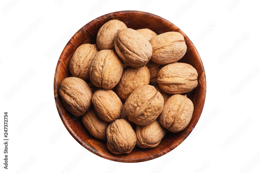 Whole nuts in shells in round container with empty copy space. Walnuts in wooden bowl isolated on white studio background. Whole nuts in shells in round container with empty copy space. Walnuts in wooden bowl isolated on white studio background.