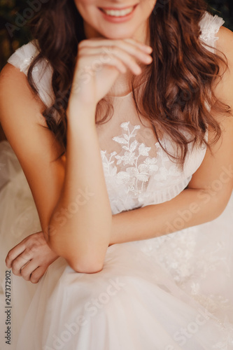Portrait of beautiful young woman in white wedding dress smiling