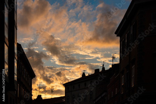 Silouhette of city roofs in a dramatic sunset