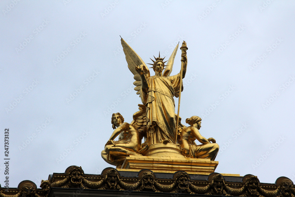 Golden statue of Angel on the top of the Garnier Opera in Paris, France (The Poetry by Charles Gumery)