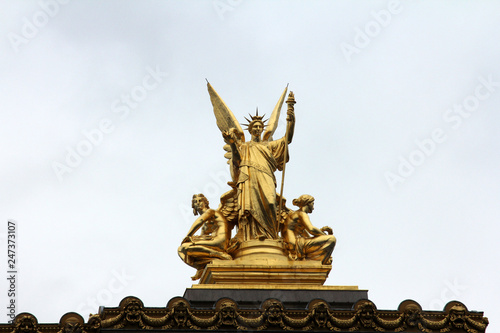Golden statue of Angel on the top of the Garnier Opera in Paris, France (The Poetry by Charles Gumery)
