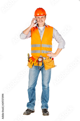 Portrait of a male builder in a helmet  looking at camera over white wall background. repair, construction, building, people and maintenance concept. © kaninstudio