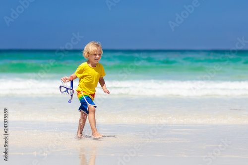 Child snorkeling on tropical beach. Kids snorkel.