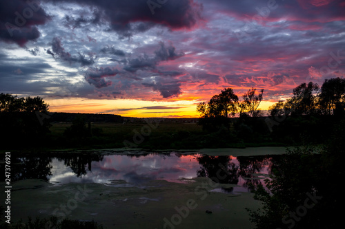 Beautiful lilac sunset over the river  pink and lilac clouds