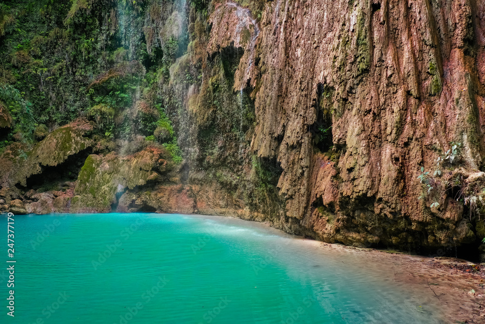 Tumalog waterfall in a mountain gorge in the tropical jungle of the Philippines, Cebu. Tumalog waterfall in a mountain gorge in the tropical jungle of the Philippines, Cebu.