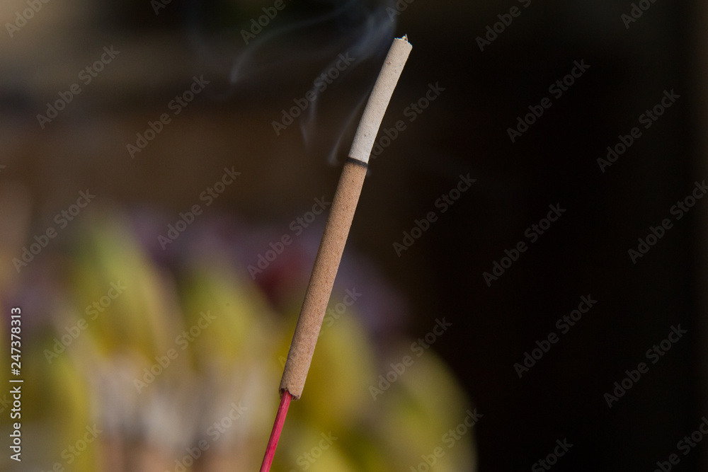 Incense stick and smoke from incense burning..