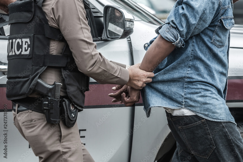 Fototapeta premium Police arrested the culprit,Police steel handcuffs,Police arrested,Police arrested the wrongdoer.