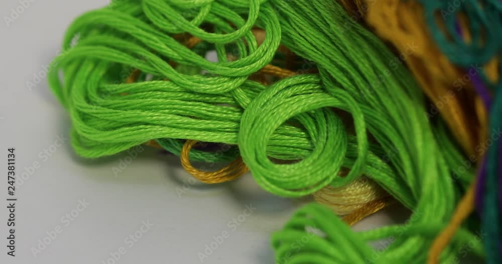 Rows spools of thread of different colors in the industrial sewing ...