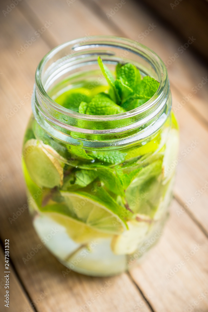 Lime, mint and ginger detox drink in jar. Selective focus. Lime, mint and ginger detox drink in jar. Selective focus.