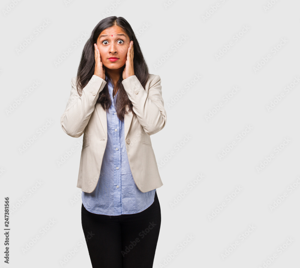 Young business indian woman covering ears with hands, angry and tired of hearing some sound Young business indian woman covering ears with hands, angry and tired of hearing some sound