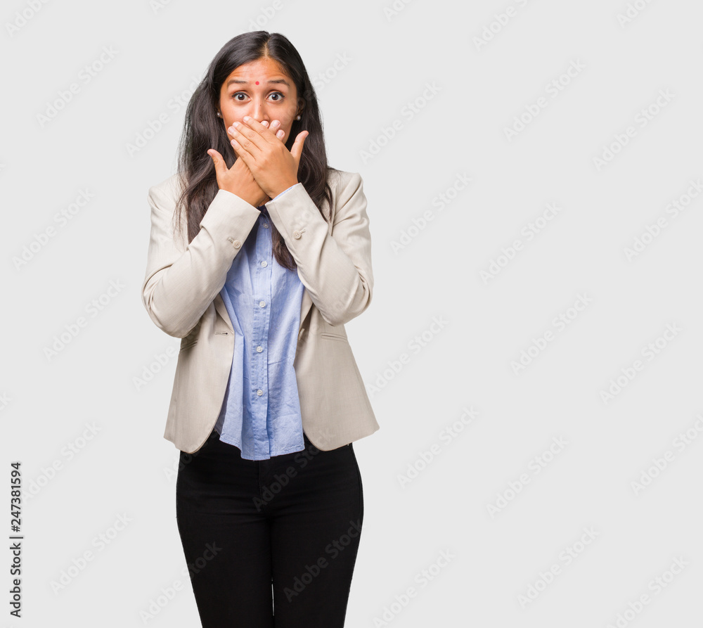 Young business indian woman covering mouth, symbol of silence and repression, trying not to say anything Young business indian woman covering mouth, symbol of silence and repression, trying not to say anything