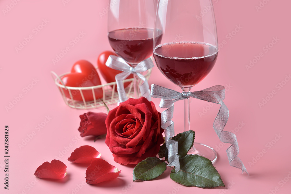 Red wine in glass, with rose at the bottom on pink background. Concept of Valentine's Day, pop art contemporary, celebrate.