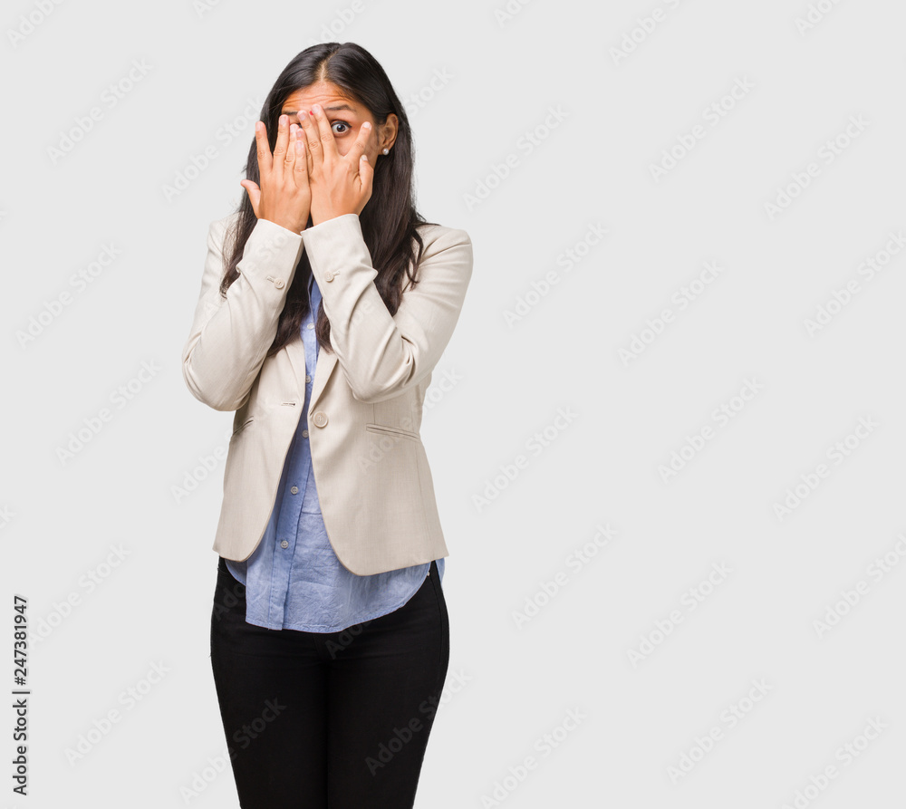 Young business indian woman feels worried and scared, looking and covering face, concept of fear and anxiety Young business indian woman feels worried and scared, looking and covering face, concept of fear and anxiety