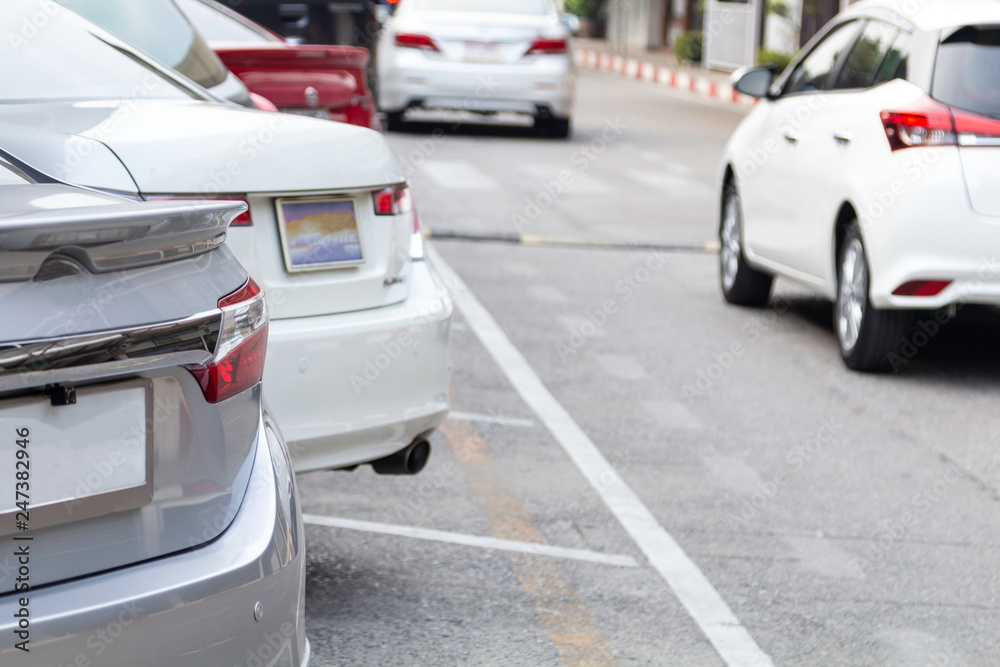 Car parking line with car running in back. Car parking line with car running in back.