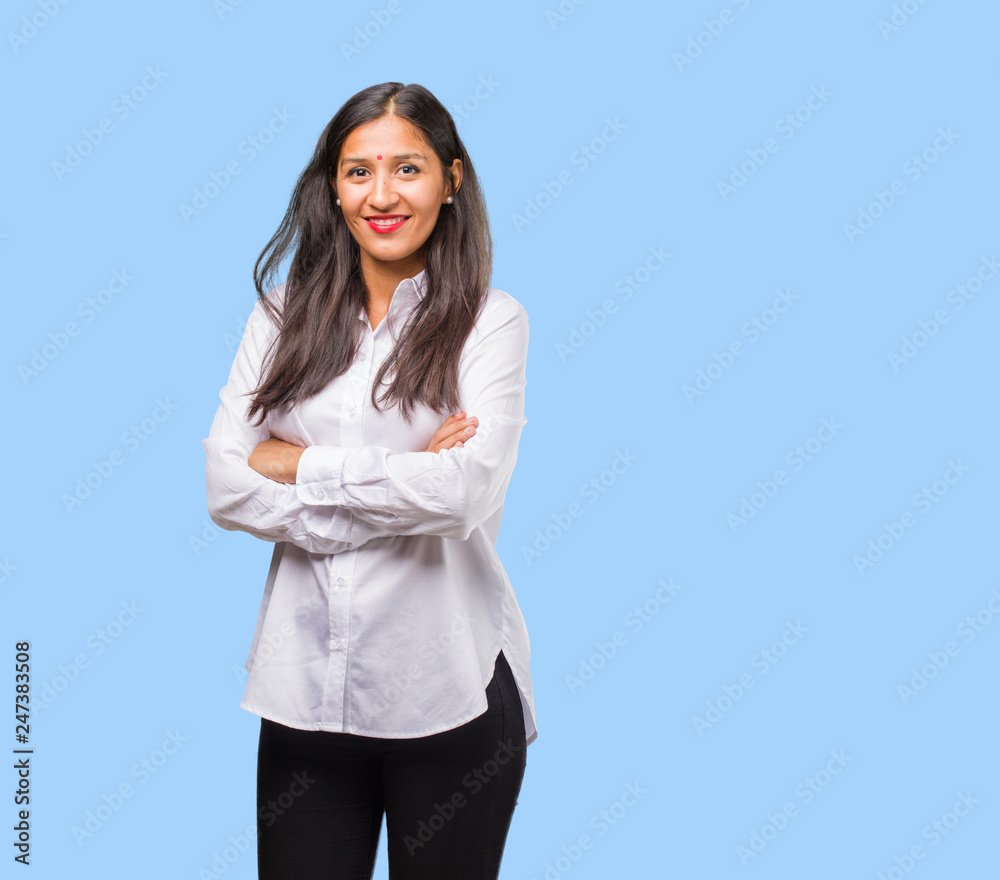 Portrait of a young indian woman crossing his arms, smiling and happy, being confident and friendly Portrait of a young indian woman crossing his arms, smiling and happy, being confident and friendly