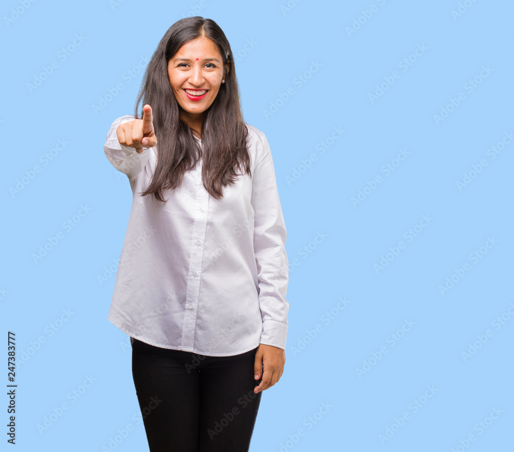 Portrait of a young indian woman cheerful and smiling pointing to the front Portrait of a young indian woman cheerful and smiling pointing to the front