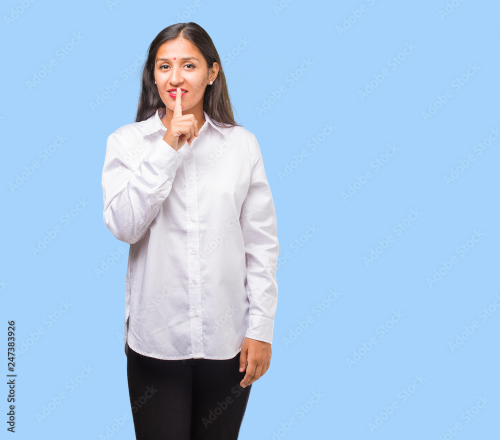 Portrait of a young indian woman keeping a secret or asking for silence, serious face, obedience concept Portrait of a young indian woman keeping a secret or asking for silence, serious face, obedience concept