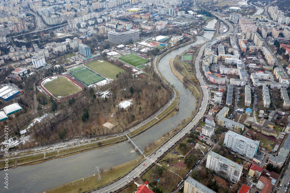 Aerial above view of river crossing the city