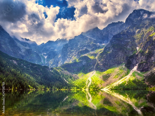 Amazing nature, alpine lake in the mountains, scenic summer landscape with blue cloudy sky and reflection in the water, Morske Oko (Eye of the Sea), Tatra Mountains, Zakopane, Poland