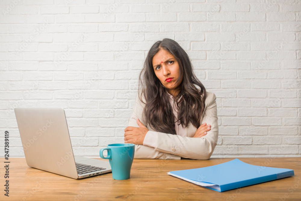 Young indian woman at the office very angry and upset, very tense, screaming furious, negative and crazy Young indian woman at the office very angry and upset, very tense, screaming furious, negative and crazy