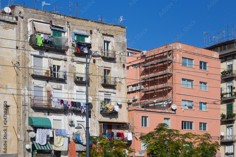 View to the old shabby residential building in the non-touristic part of Naples. View to the old shabby residential building in the non-touristic part of Naples.