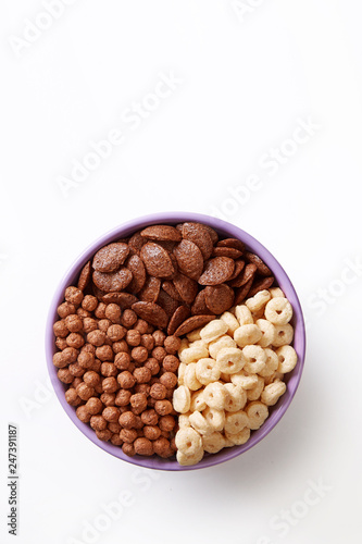Bowl of various cereals isolated on a white background viewed from above. Top view. Copy space