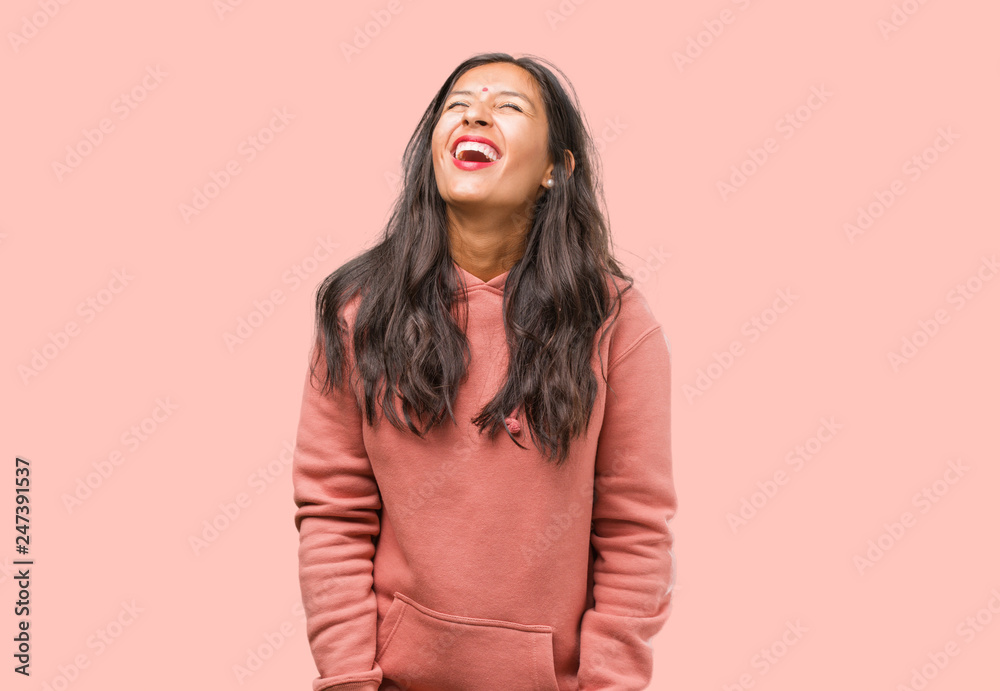 Portrait of fitness young indian woman laughing and having fun, being relaxed and cheerful, feels confident and successful