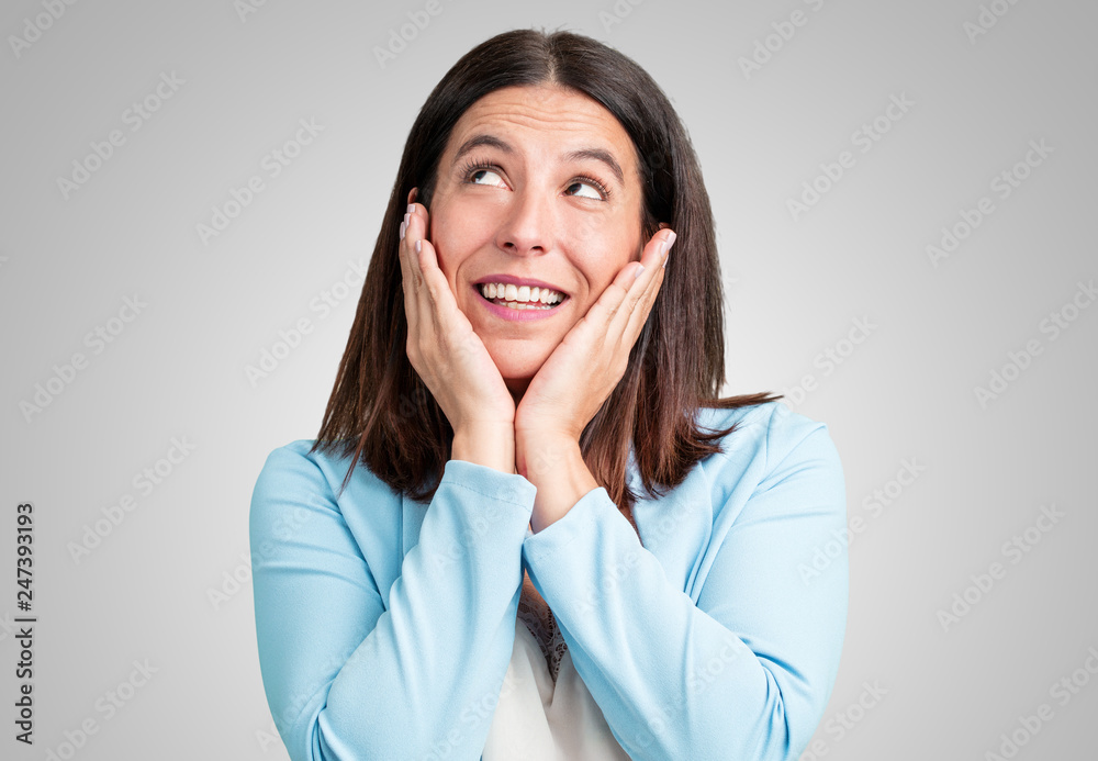 Middle aged woman surprised and shocked, looking with wide eyes, excited by an offer or by a new job, win concept Middle aged woman surprised and shocked, looking with wide eyes, excited by an offer or by a new job, win concept
