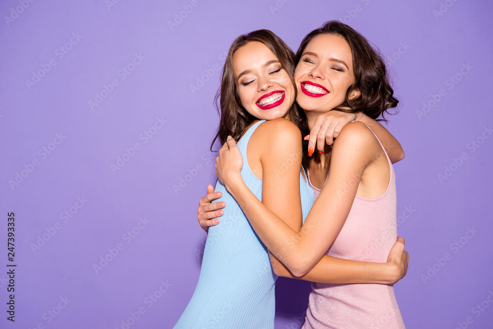 Close up portrait two stunning beautiful she her lady eyes closed missed bright lipstick white teeth hold hands arms circle close wear festive dresses isolated purple violet vivid vibrant background Close up portrait two stunning beautiful she her lady eyes closed missed bright lipstick white teeth hold hands arms circle close wear festive dresses isolated purple violet vivid vibrant background