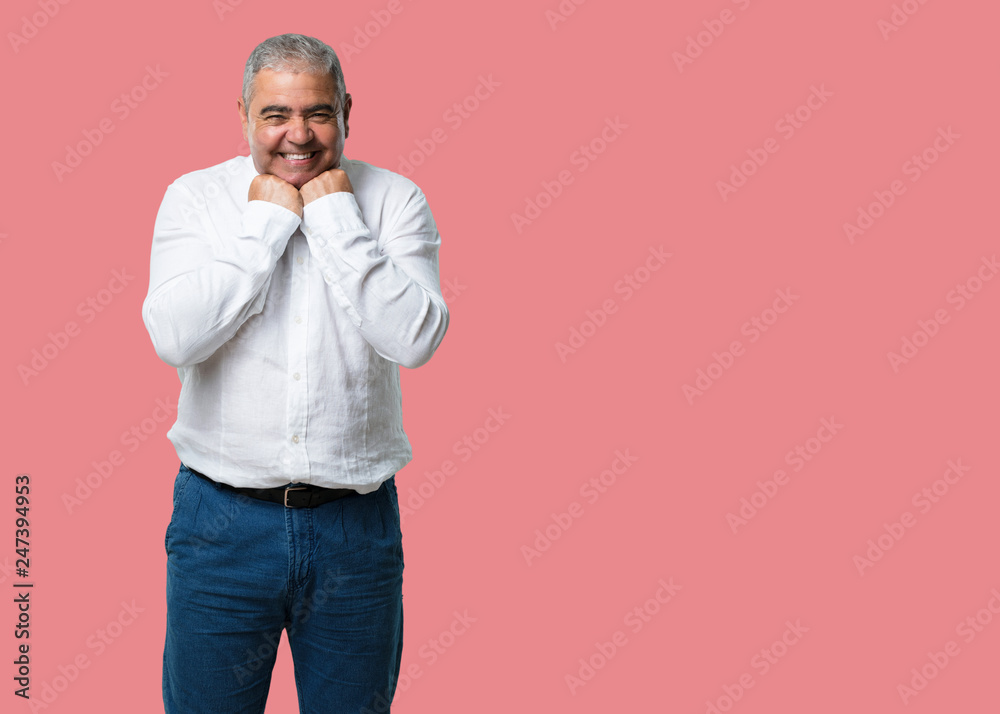 Middle aged man very happy and excited, raising arms, celebrating a victory or success, winning the lottery Middle aged man very happy and excited, raising arms, celebrating a victory or success, winning the lottery