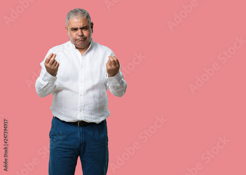 Middle aged man sad and depressed, making a gesture of need, restoring to charity, concept of poverty and misery