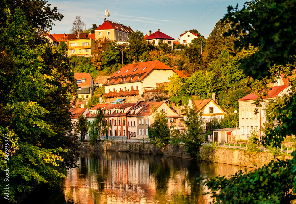 Evening sunlight senery of river and old buildings on the slope of the city Cesky Krunlov