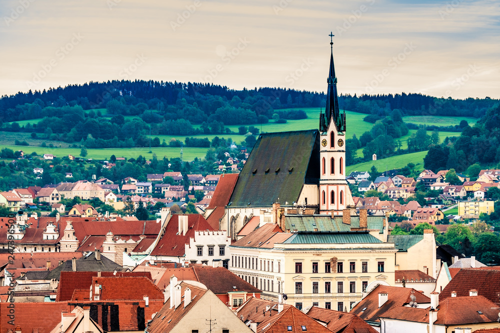 Top view of old architecture of Cesky Krumlov on the background of green forest hills