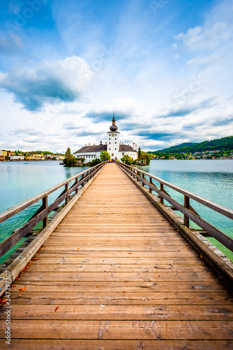 Fototapeta Naklejka Na Ścianę i Meble -  Amazing view of wooden bridge to the Schloss Ort castle and landscape around in Gmunden, Austria