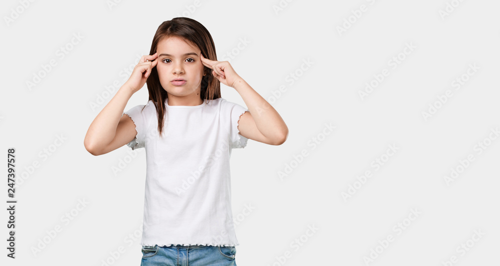Full body little girl man making a concentration gesture, looking straight ahead focused on a goal Full body little girl man making a concentration gesture, looking straight ahead focused on a goal