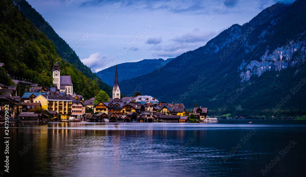Amazing night scenery of austrian town Hallstatt at the lake and high mountains