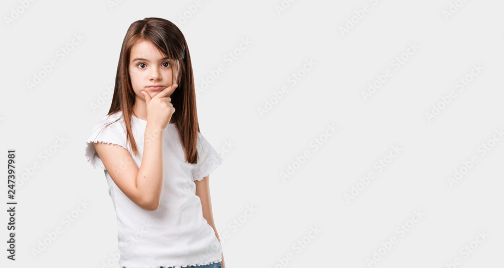Full body little girl thinking and looking up, confused about an idea, would be trying to find a solution Full body little girl thinking and looking up, confused about an idea, would be trying to find a solution