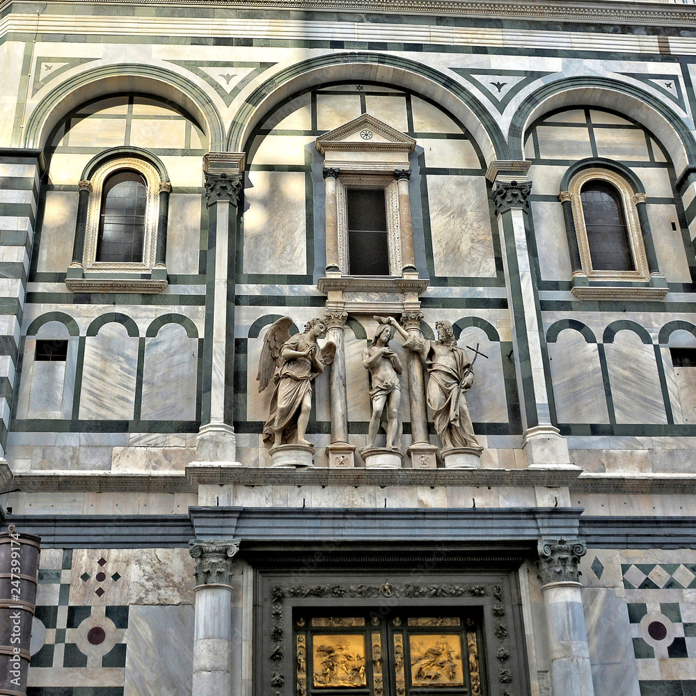 Baptizing. Architectural details of the Baptistery, which is one of the oldest buildings in Florence. Iconic octagonal basilica with striking marble facade, known for its bronze doors. Italy, Florence