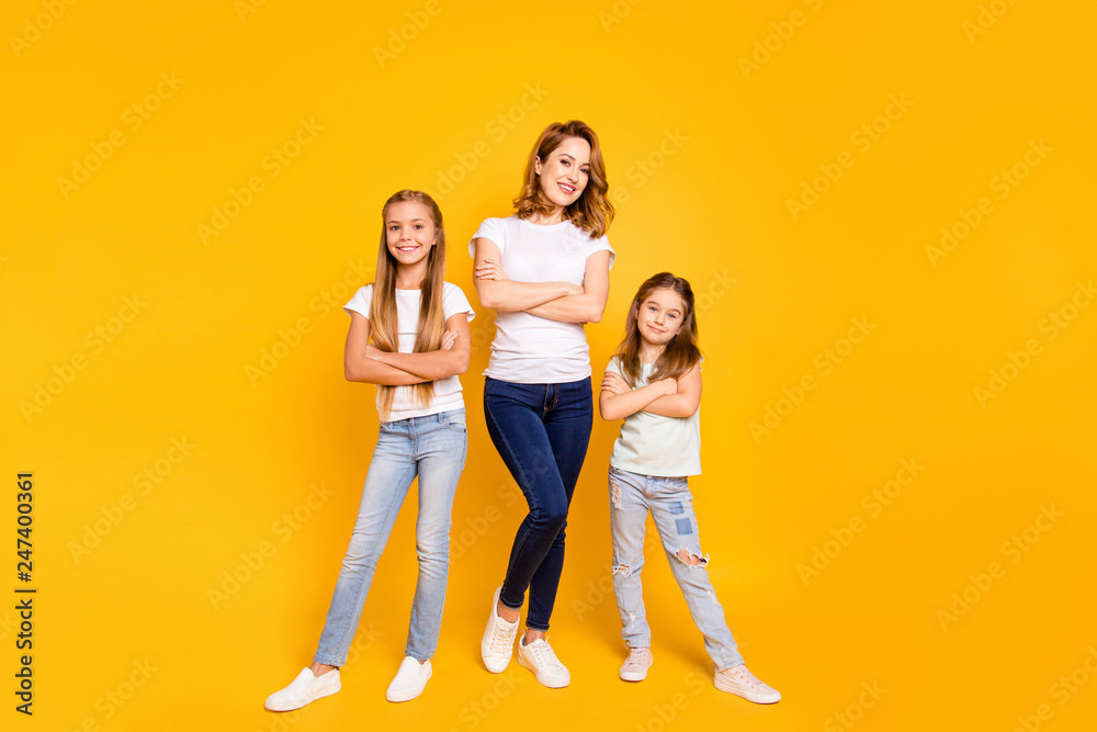 Naklejka premium Full length body size view portrait of three nice attractive slim cheerful cheery people folded arms mum mommy isolated over bright vivid shine yellow background