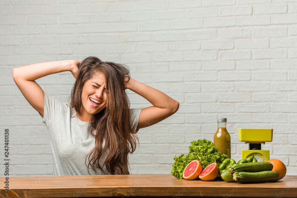 Concept of diet. Portrait of a healthy young latin woman crazy and desperate, screaming out of control, funny lunatic expressing freedom and wild Concept of diet. Portrait of a healthy young latin woman crazy and desperate, screaming out of control, funny lunatic expressing freedom and wild